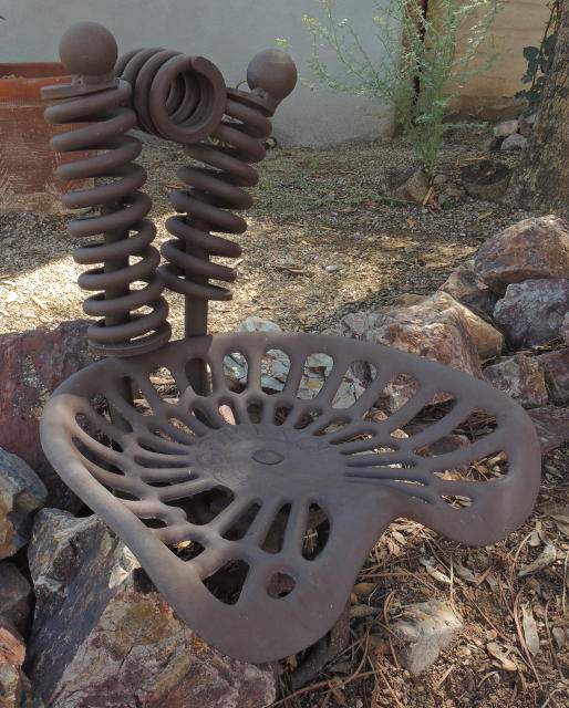 Chair made of springs and an old tractor seat at Springerville pocket park, Tucson, Arizona